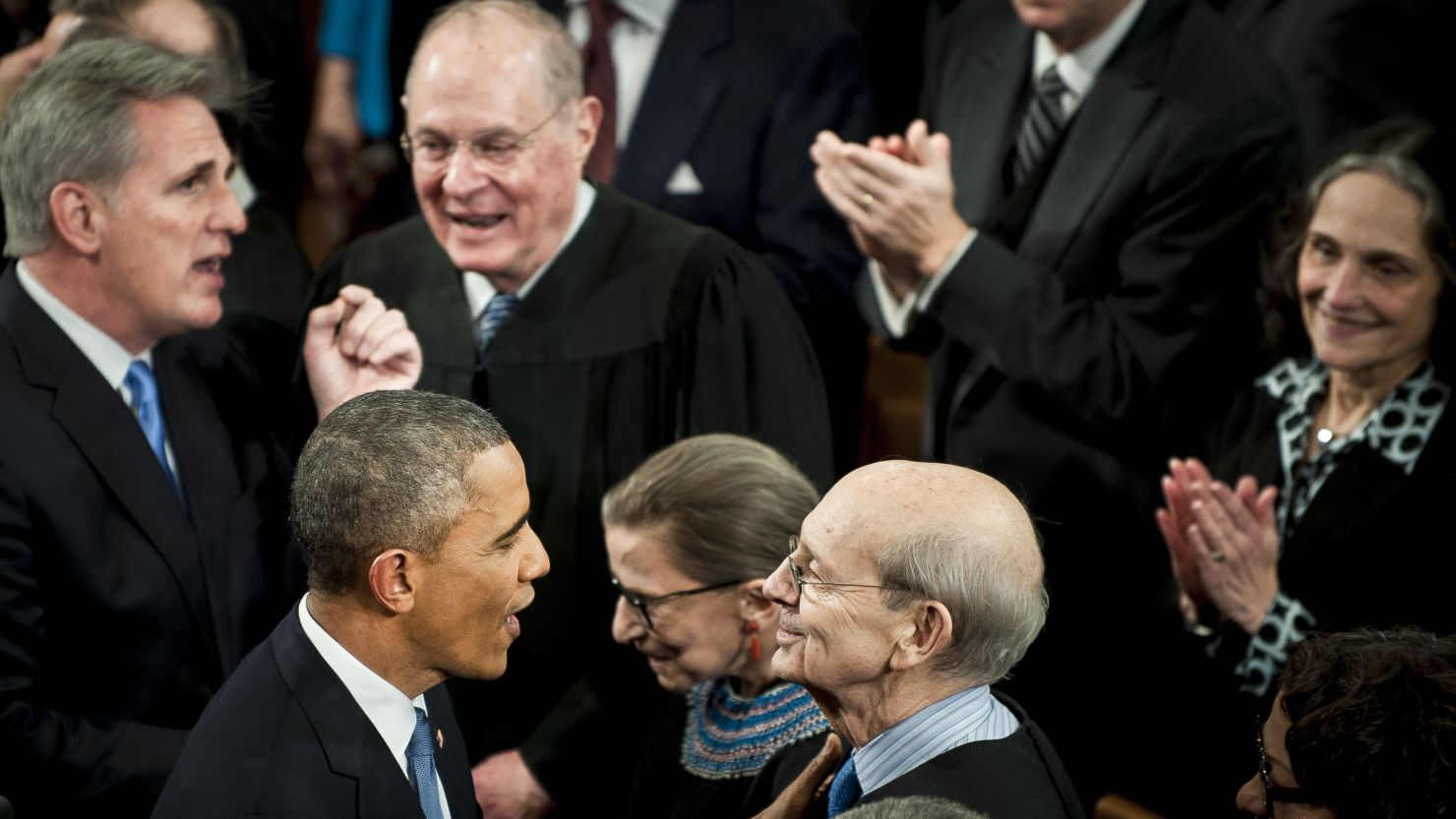 U.S. President Barack Obama, center left, speaks with Supreme Court Justice Stephen Breyer, center right, as he enters the House Chamber to deliver the State of the Union address to a joint session of Congress at the Capitol in Washington, U.S., on Tuesday, Jan. 20, 2015.
