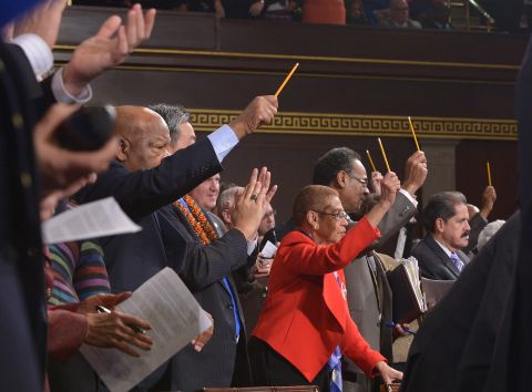 U.S. lawmakers pay tribute to the victims of the Paris terrorist attacks by holding up pencils during the speech.