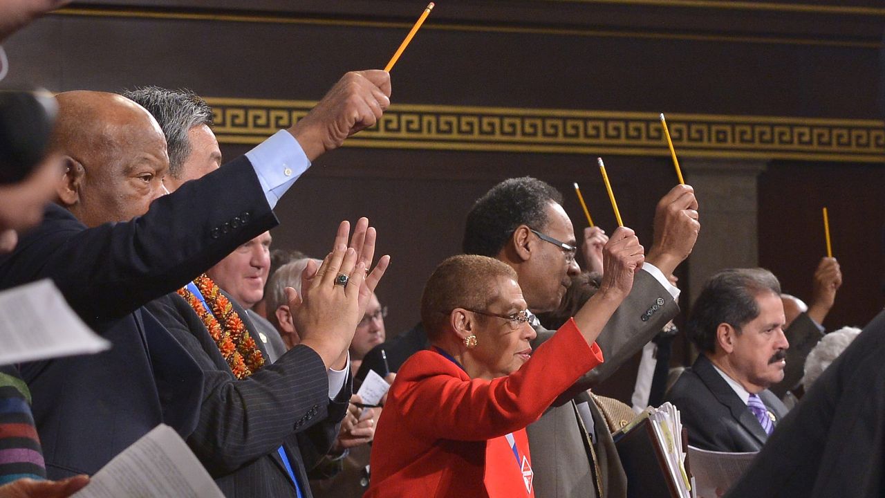 U.S. lawmakers pay tribute to the victims of the Paris terrorist attacks by holding up pencils during President Barack Obama's State of the Union address.