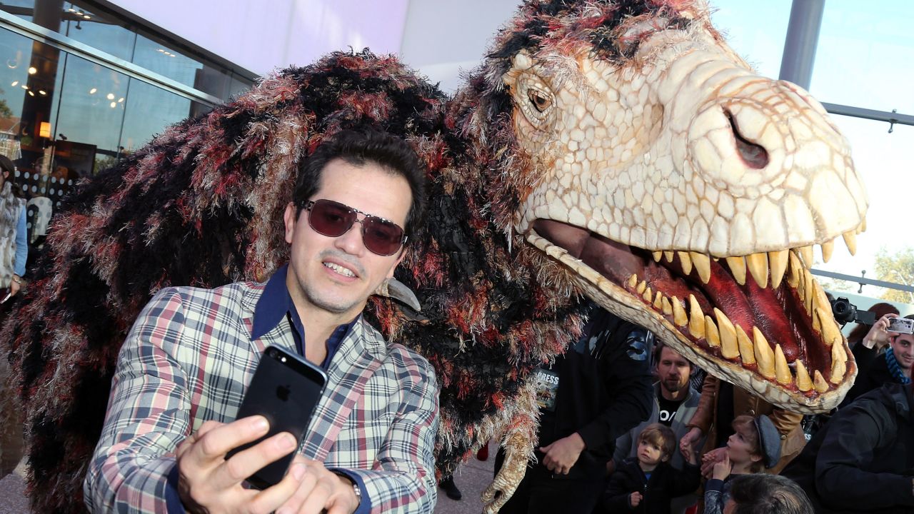 Actor John Leguizamo shoots a selfie at the "Walking with Dinosaurs" press event at the Los Angeles Natural History Museum.
