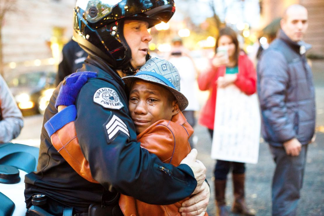 12-year-old Devonte Hart, Sgt. Bret Barnum share hug at Ferguson rally