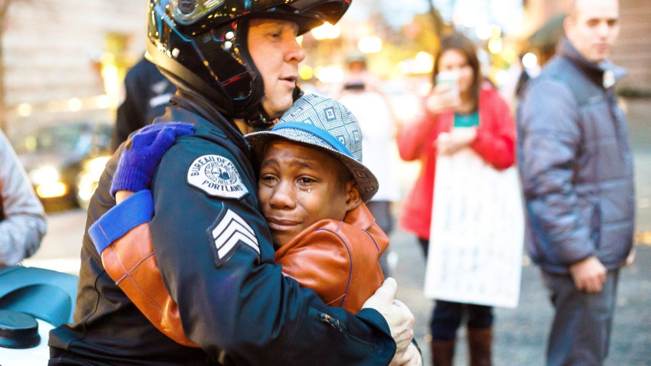 12-year-old Devonte Hart, Sgt. Bret Barnum share hug at Ferguson rally