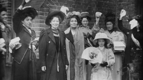 English suffragettes Emmeline Pankhurst (center) and her daughter Christabel Harriette (third from left) are cheered by supporters after their release from prison in 1908. 