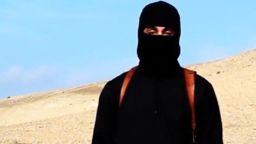 A video released by ISIS on social media Tuesday, Jan. 20, 2015, purportedly shows a masked man standing over two kneeling men in orange jumpsuits. The terror groups threatened to kill the two Japanese hostages unless Tokyo pays $200 million.