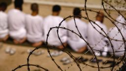 File photo: Detainees kneel during an early morning Islamic prayer in their camp at Guantanamo