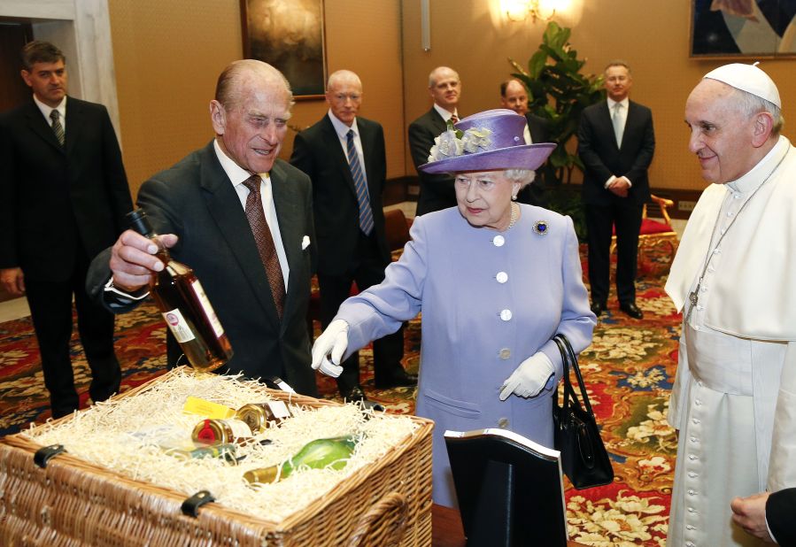 Here, the British monarch and her husband Prince Philip present Pope Francis with a hamper of food and drink.