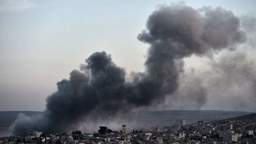 Smoke rises after an airstrike from US-led coalition in the city of Kobane, also known as Ain al-Arab, seen from the southeastern border village of Mursitpinar, Sanliurfa province, on November 9, 2014. AFP PHOTO / ARIS MESSINIS (Photo credit should read ARIS MESSINIS/AFP/Getty Images)