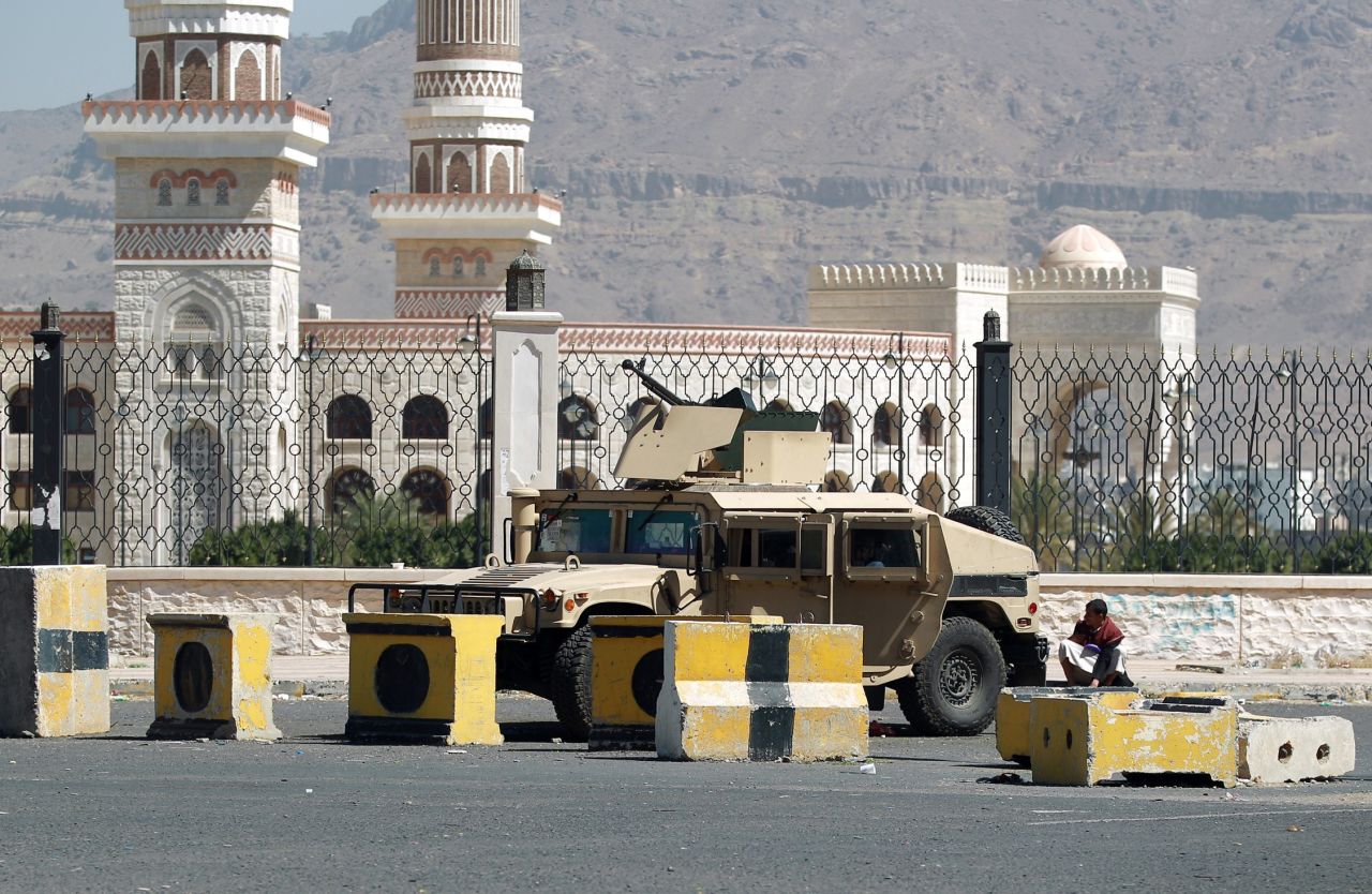 A Houthi militiaman sits near a tank near the presidential palace in Sanaa on Thursday, January 22.