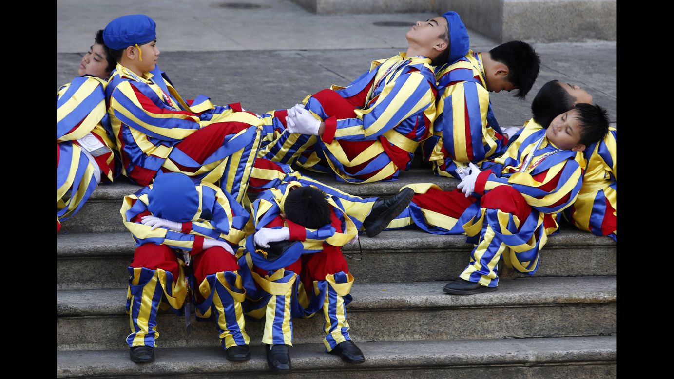 Schoolchildren dressed as Swiss Guards rest outside the Manila Cathedral as they wait for Pope Francis to arrive in Manila, Philippines, on Friday, January 16. <a href="http://www.cnn.com/2015/01/13/world/gallery/pope-in-asia/index.html" target="_blank">See more photos from the Pope's weeklong trip to Asia</a>