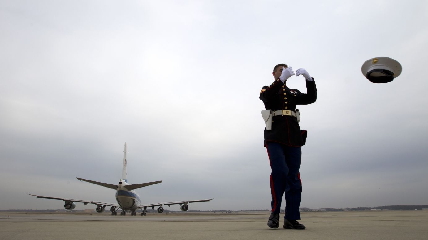 The jet exhaust from Air Force One blows the hat off U.S. Marine Cpl. Chaz Sorensen as it departs Andrews Air Force Base in Maryland on Wednesday, January 21.