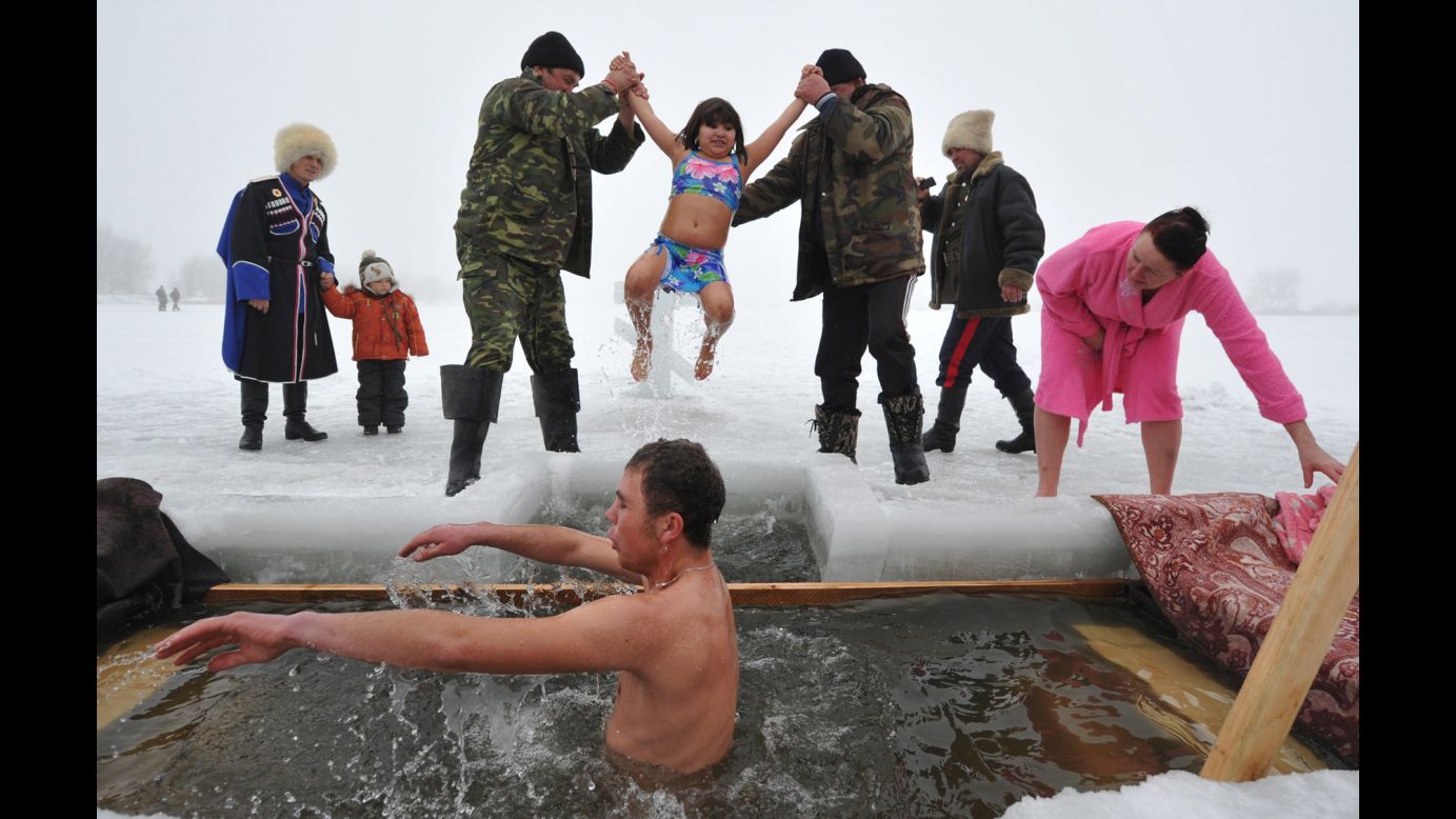 Orthodox Christians near the village of Sretenka, Kyrgyzstan, dip into the icy waters of a lake while celebrating the Epiphany holiday on Monday, January 19. Among Orthodox Christians, the feast of Epiphany celebrates the day the spirit of God descended upon believers in the shape of a dove during Jesus Christ's baptism in the river Jordan.