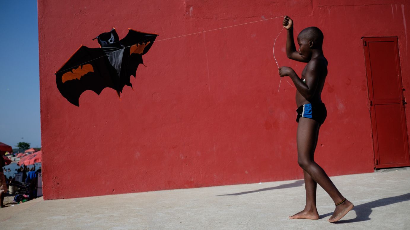 A boy plays with a kite at the Ramos Pool, an artificial beach in Rio de Janeiro, as temperatures reached 45 degrees Celsius (113 degrees Fahrenheit) on Monday, January 19.