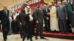 King Abdullah is escorted by Turkish President Abdullah Gul, cneter right, as Lebanese Prime Minister Najib Mikati, left, walks alongside them during a summit the Organisation of the Islamic Conference (OIC) in Mecca on August 14, 2012. 