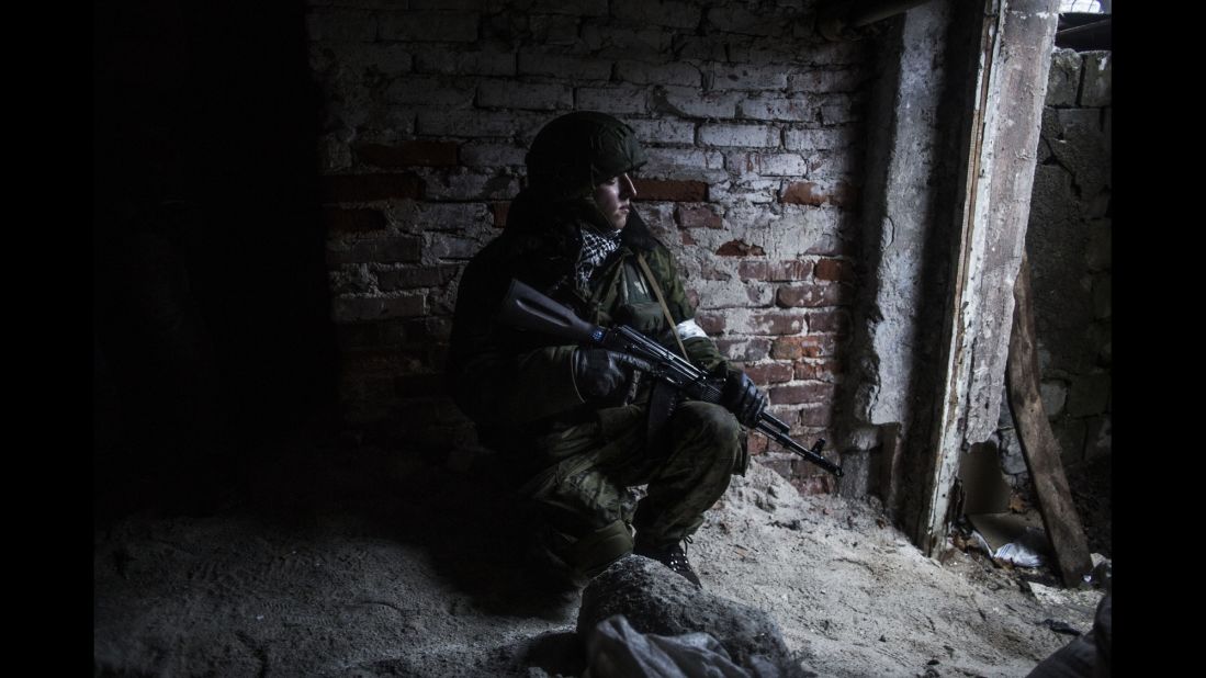 A pro-Russian rebel takes cover from shelling in the Kievsky district of Donetsk on Thursday, January 22.
