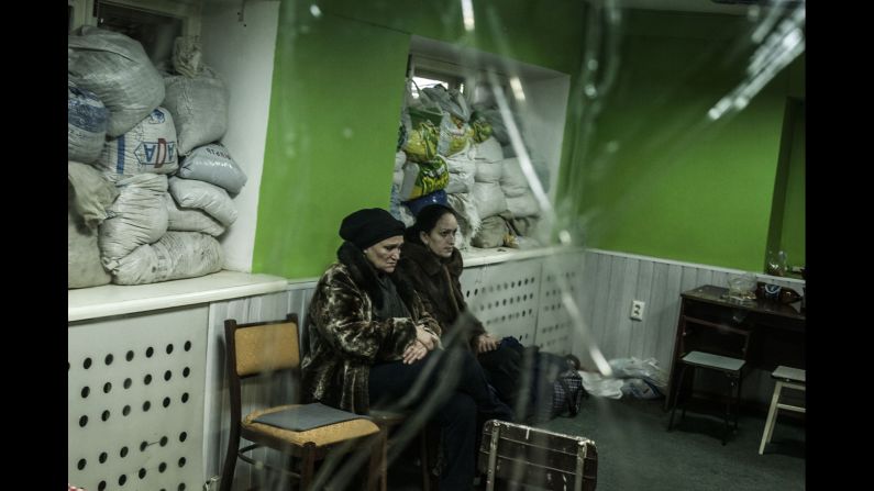 Women sit in a shelter during a battle in Donetsk on Sunday, January 18.