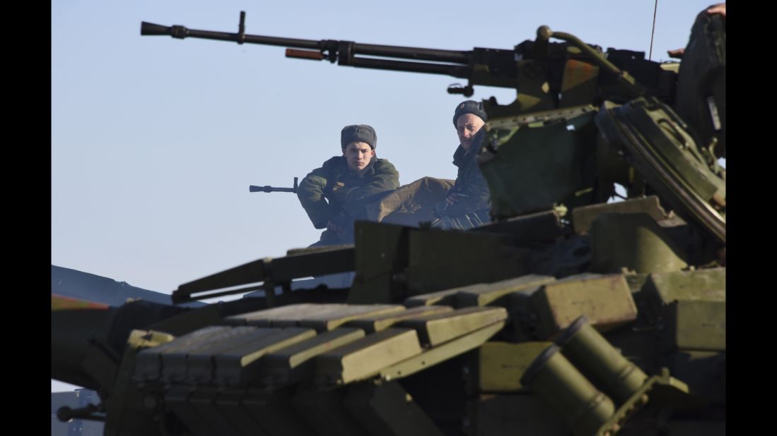 Rebels sit atop a tank at a checkpoint north of Luhansk, Ukraine, on Wednesday, January 14.