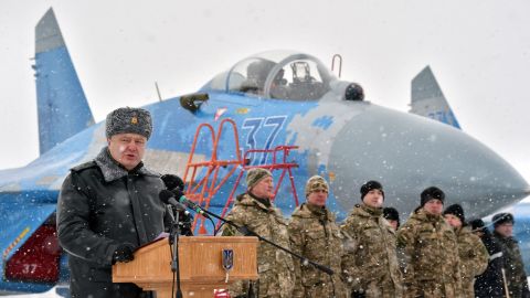 Ukrainian President Petro Poroshenko gives a speech as he hands over new military equipment to forces near the city of Ghytomyr, Ukraine, on Monday, January 5.