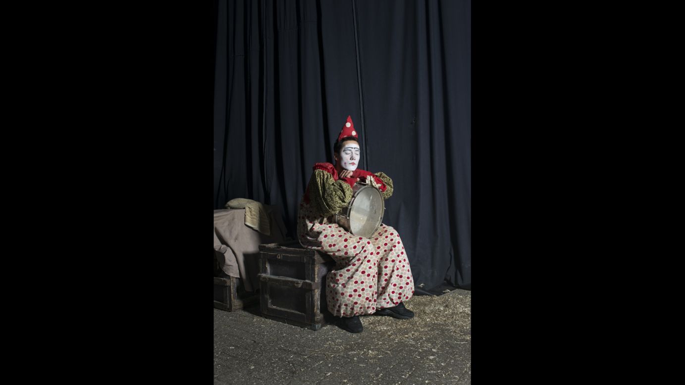 A clown takes a break backstage.