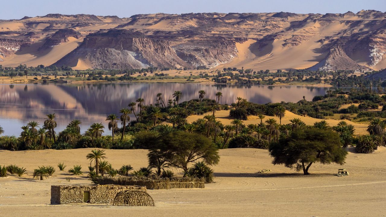 The 18 interconnected lakes of Ounianga in the landlocked African nation of Chad are lined with palms, dunes and sandstone formations. Some of the lakes are covered with floating green reeds, offering an intense contrast against the blue water. Others are so salty the rocky shore is encrusted in white salt deposits.