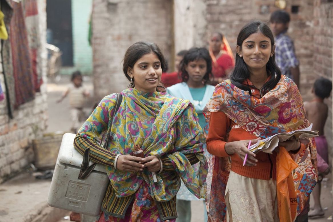 House-to-house polio vaccination team members Heena Khatun and Rukhsar Khatun work in the Kamla Nehru Nagar slum in Patna, India, in December 2010. 
