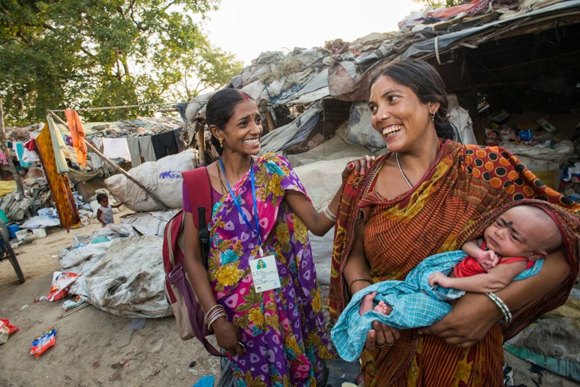 An ASHA worker visits the Chandan slum to discuss general health concerns and family planning practices with residents in Uttar Pradesh, India, on June 4, 2014. 