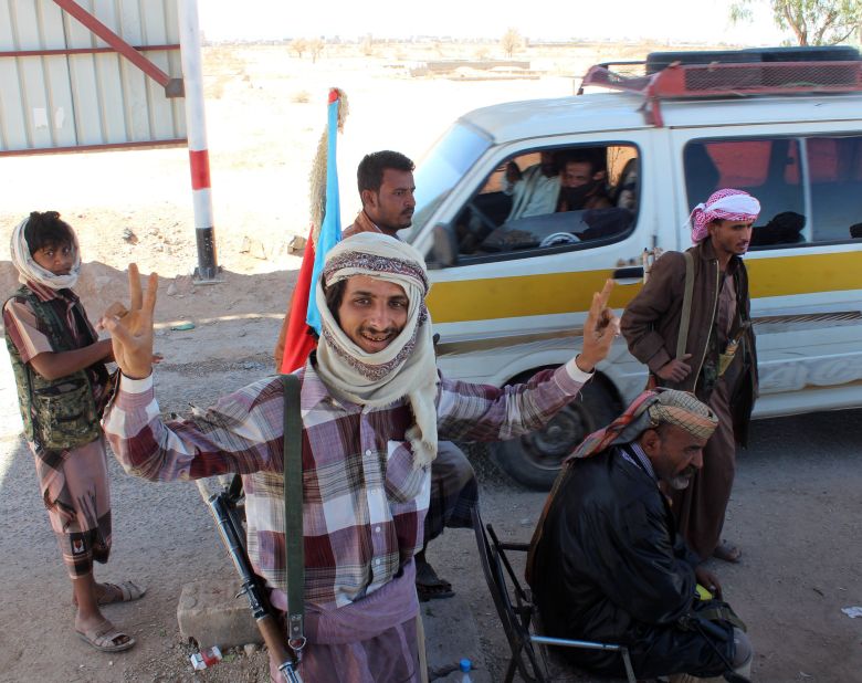 Supporters of the separatist Southern Movement flash the victory sign after they seized police security checkpoints on Saturday, January 24, in Ataq, the capital of the Shabwa province in Yemen. Policemen were told to give up their weapons and return to their bases before the militiamen raised flags of the formerly independent South Yemen at the checkpoints.