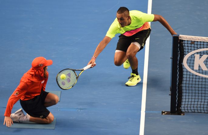 Kyrgios of Australia gets up close and personal with a ball boy during epic win against Seppi.