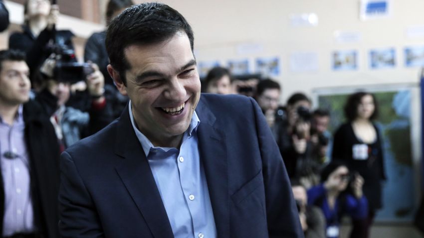 Alexis Tsipras, leader of Greece's Syriza left-wing main opposition party laughs as he arrives to cast his vote at a polling station in Athens, Sunday, Jan. 25, 2015.