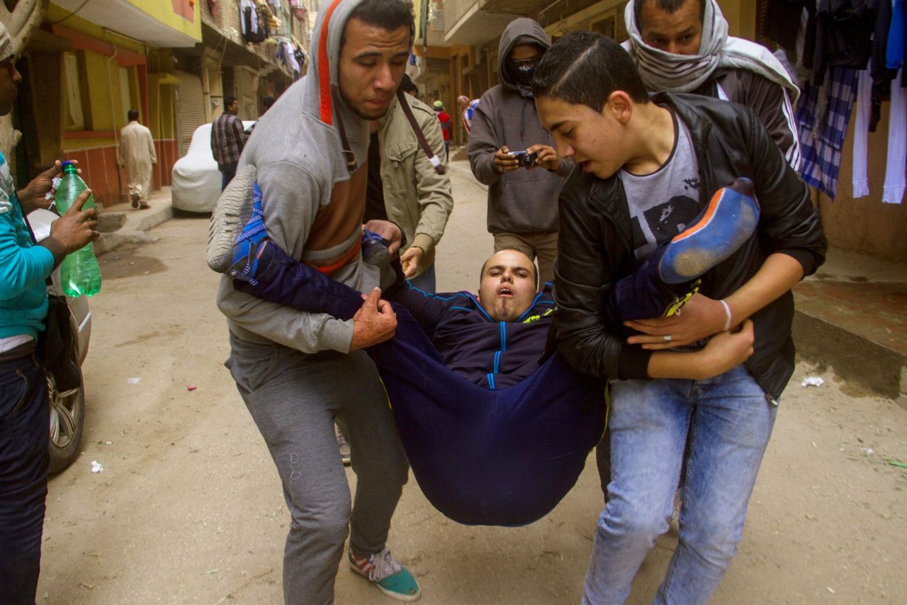 An injured protester is carried during the protests on January 25.