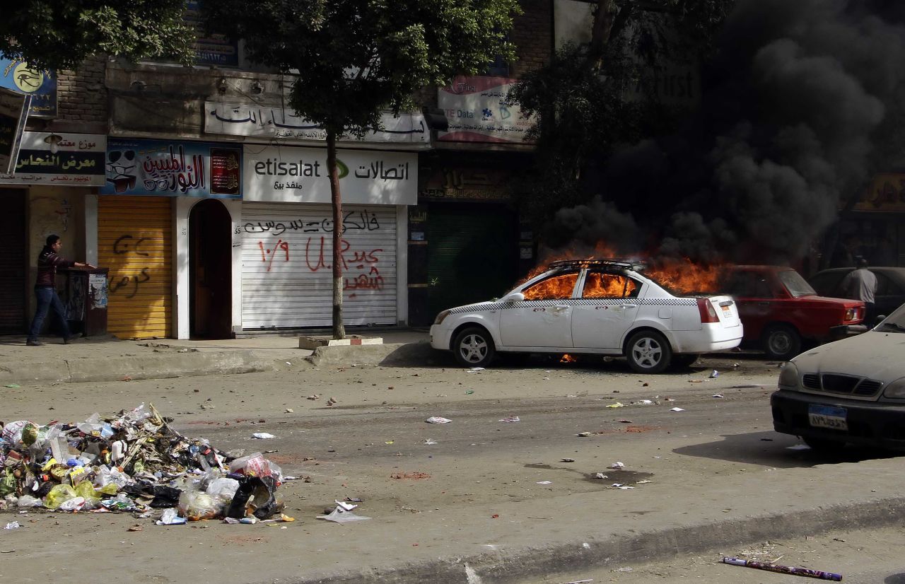 A taxi burns during clashes in the Cairo suburb of Matariyah on January 25. 