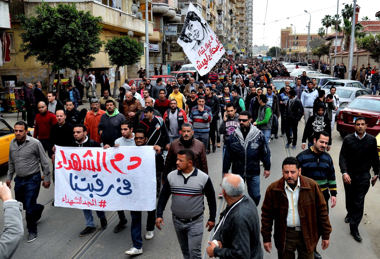 Egyptians march in the funeral procession of Shaimaa El-Sabbagh in Alexandria, Egypt, on January 25. El-Sabbagh  was shot Saturday in downtown Cairo while taking part in a gathering commemorating   protesters killed in the revolution.