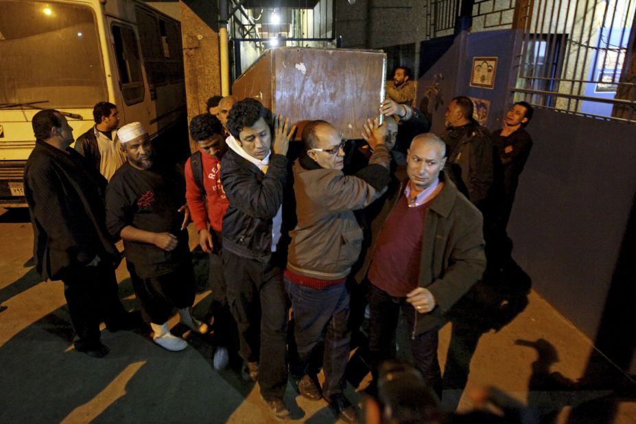 The coffin of  Shaimaa El-Sabbagh is carried out of the Zenhom morgue in Cairo early on January 25. 