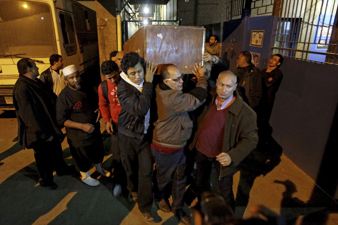 The coffin of Shaimaa El-Sabbagh is carried out of the Zenhom morgue in Cairo early on January 25.