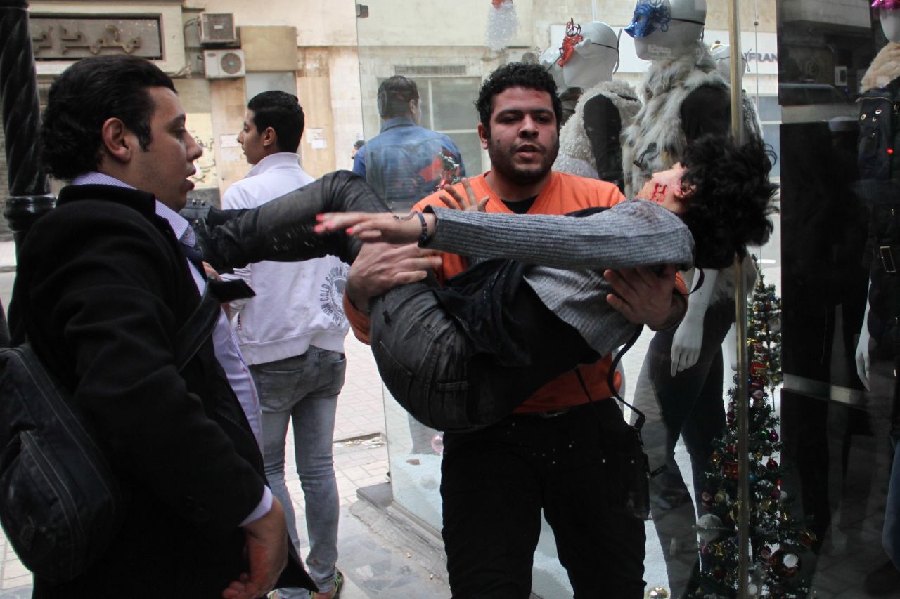 A man carries activist Shaimaa El-Sabbagh after she was shot near Tahrir Square during the protests on Saturday, January 24. Protests marking the anniversary of the 2011 uprising that toppled Egyptian President Hosni Mubarak have turned deadly. The death of Cairo protester Shaimaa El-Sabbagh was captured on video. More than a dozen others have been killed.