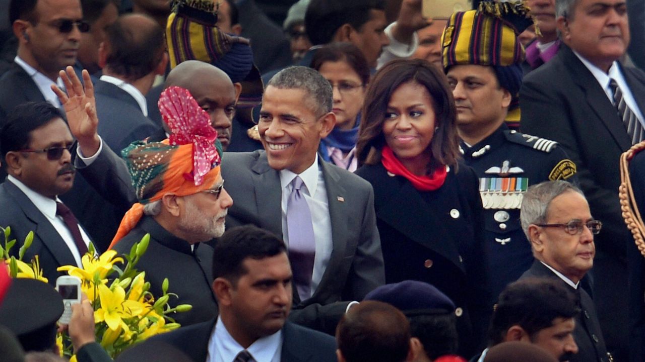 Obama waves to the crowd as he walks with Modi, left, and first lady Michelle Obama after the annual Republic Day parade in New Delhi on January 26.
