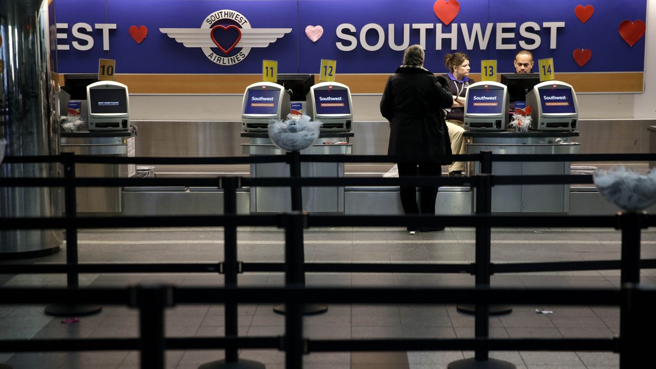 Kiosks stand empty at the Southwest Airlines counter at LaGuardia Airport on Monday morning, Jan. 26, 2015, in New York. Airlines are canceling thousands of flights into and out of East Coast airports as a major snowstorm packing up to three feet of snow barrels down on the region. (AP Photo/Seth Wenig)