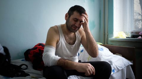 A man injured during shelling in Mariupol sits in an emergency hospital on January 26.