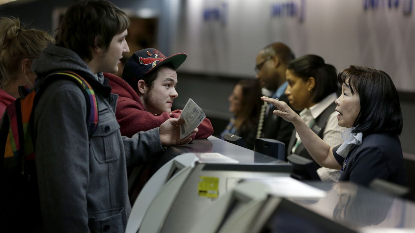 Passengers talk with a ticket agent at LaGuardia Airport to try to beat the snowstorm on January 26.