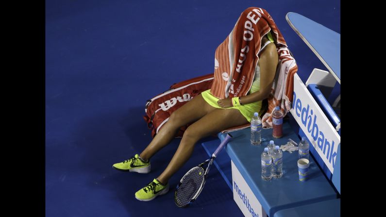 Victoria Azarenka wraps herself in a towel during a break in her Australian Open match against Dominika Cibulkova on Monday, January 26. Cibulkova won in three sets.