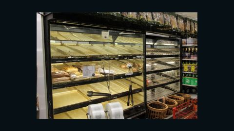 Shoppers clean out the bread shelves at a Greenwich Village grocery store
