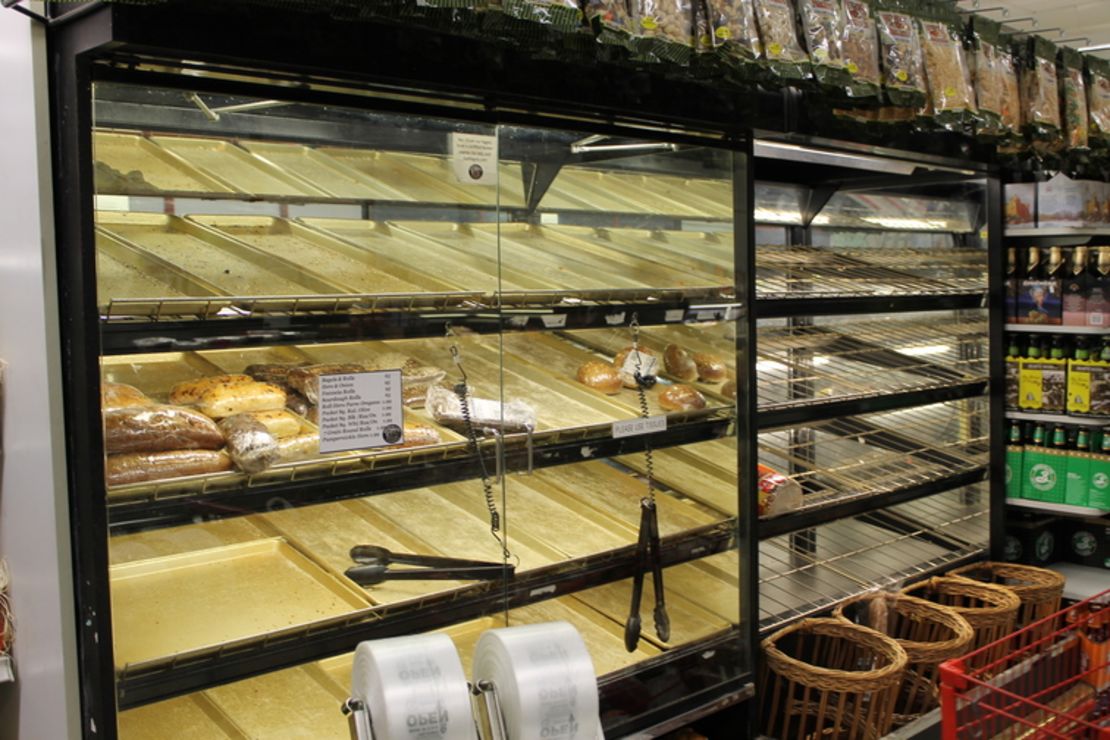 Shoppers clean out the bread shelves at a Greenwich Village grocery store