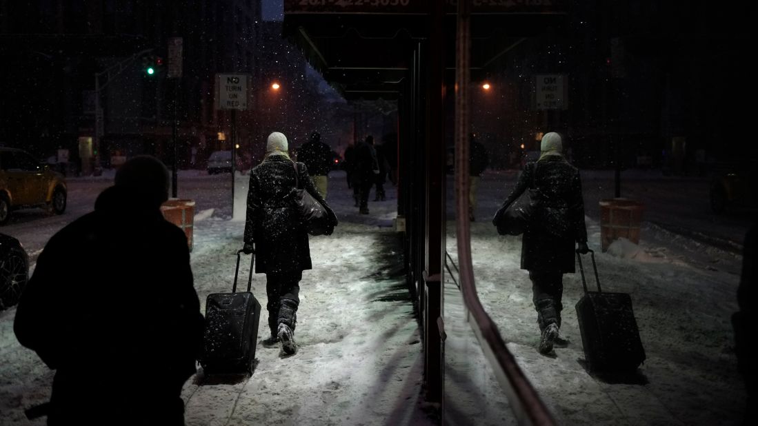 People walk through falling snow in Hoboken, New Jersey, on January 26.
