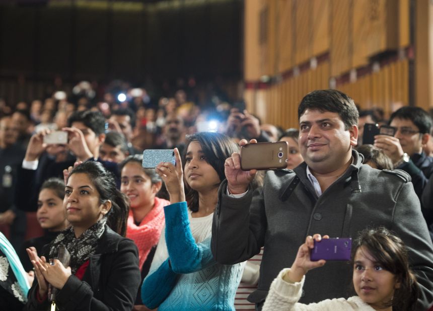 Guests use cell phones to record Obama as he speaks at the town hall event on January 27.