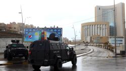 Libyan security forces and emergency services surround Tripoli's central Corinthia Hotel (R) on January 27, 2015 in the Libyan capital. The hotel was reportedly attacked by Islamist gunmen today and gunfire was heard, an AFP photographer reported.