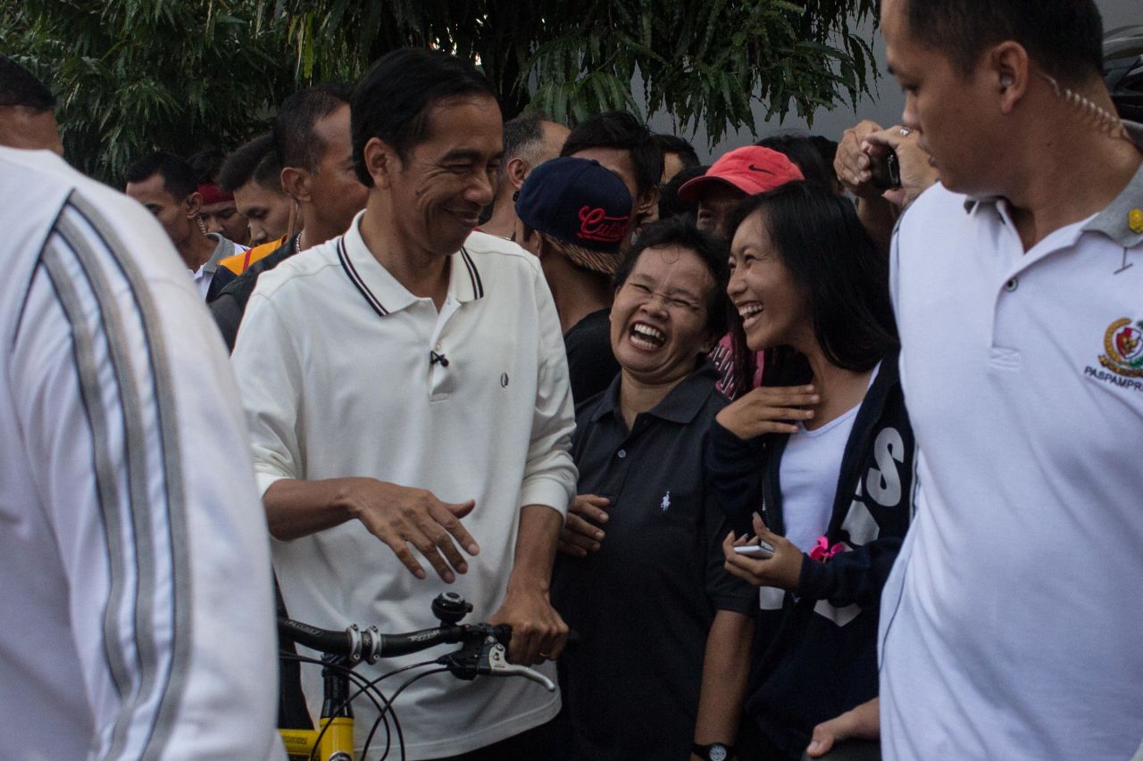 In a country long ruled by aloof presidents with ties to the military and the elite, people in Jakarta were positively giddy to see their president among them.<br />Jokowi's security team allowed the President to be jostled by young and old elbowing in for a handshake.