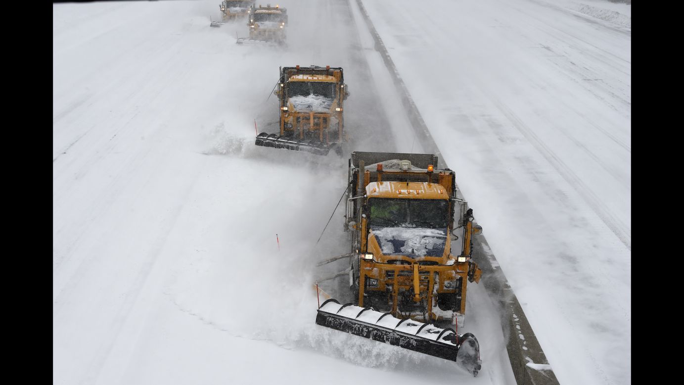 Plows clear snow off the Long Island Expressway in Melville, New York, on January 27.