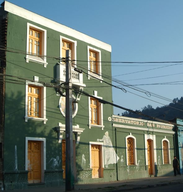 A theater company in the Barrio Bellavista neighborhood has Renaissance characters on the front of its building 