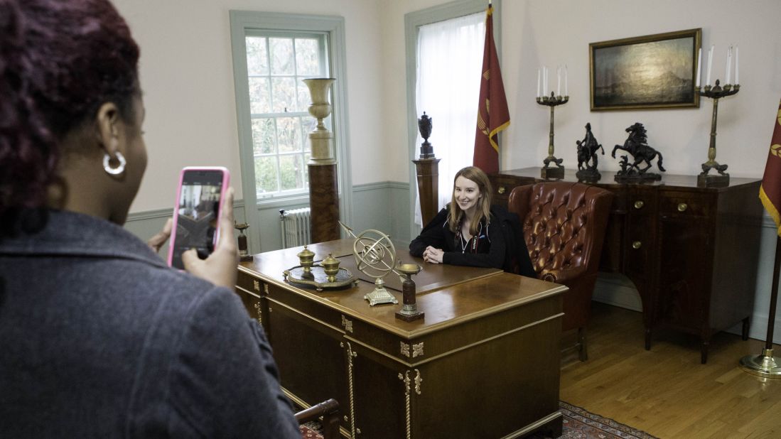 Jasmine Alyce snaps a picture of Emma Loggins of <a href="http://www.fanbolt.com" target="_blank" target="_blank">Fanbolt.com</a> at the Atlanta History Center in the room used as President Snow's office in "The Hunger Games" movies.