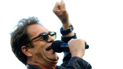 SAN FRANCISCO, CA - OCTOBER 24:  Singer Huey Lewis pumps out of the crowd before the San Francisco Giants take on the Kansas City Royals in Game Three of the 2014 World Series at AT&T Park on October 24, 2014 in San Francisco, California.  (Photo by Jamie Squire/Getty Images)