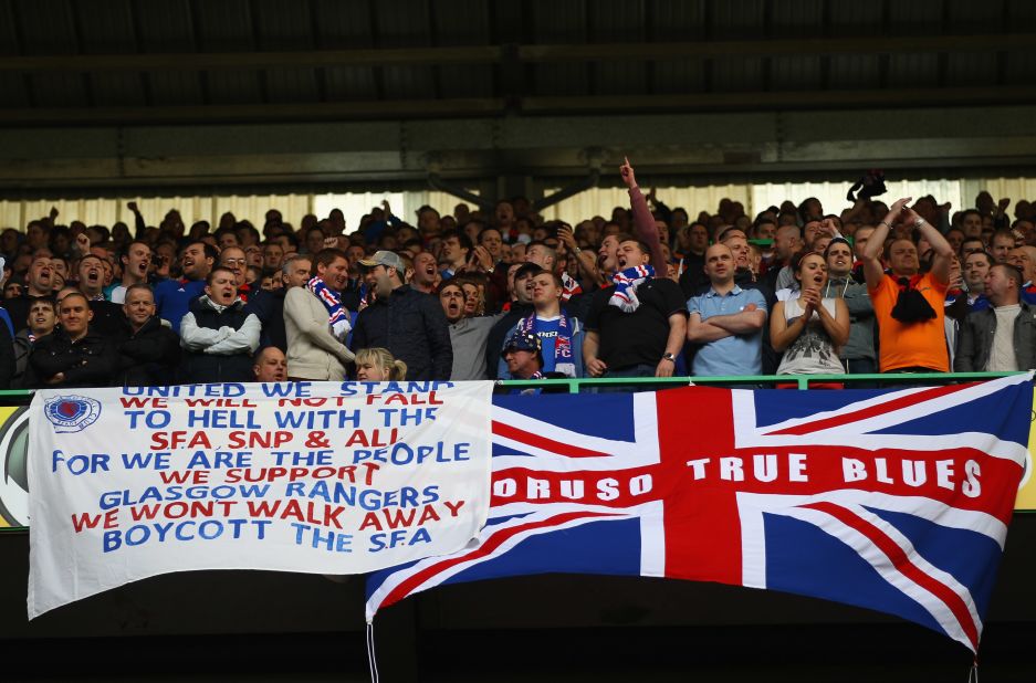 Rangers fans see things differently with the vast majority of the opinion that they are the same club as it was the company that ran the club and not the club itself that was liquidated. Here, a group of Rangers fans display a Union Jack and a banner emphasizing their support for the club at Celtic Park in 2012.